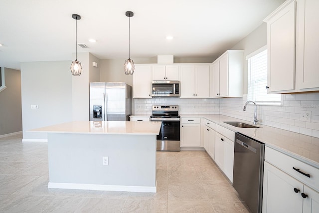 kitchen with a kitchen island, tasteful backsplash, stainless steel appliances, sink, and white cabinets