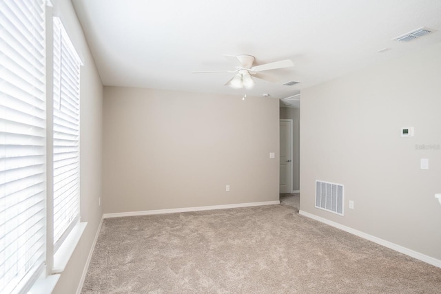 carpeted empty room featuring ceiling fan