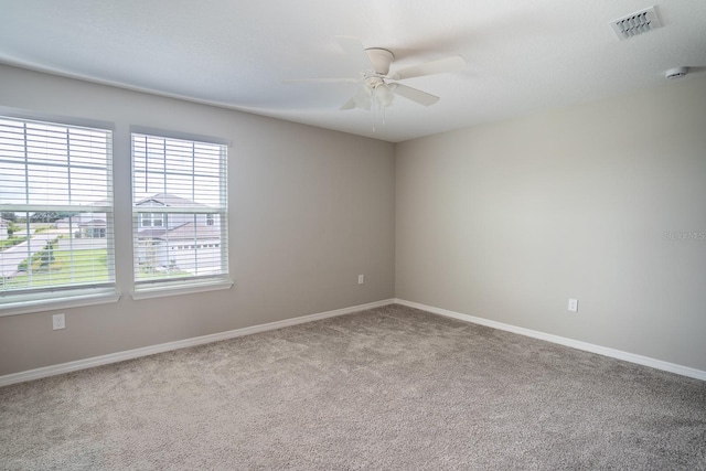 unfurnished room with ceiling fan, a textured ceiling, and carpet floors