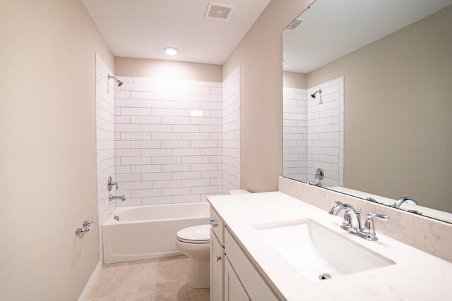 full bathroom featuring tiled shower / bath, vanity, toilet, and tile patterned flooring