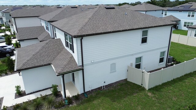 rear view of house featuring a yard