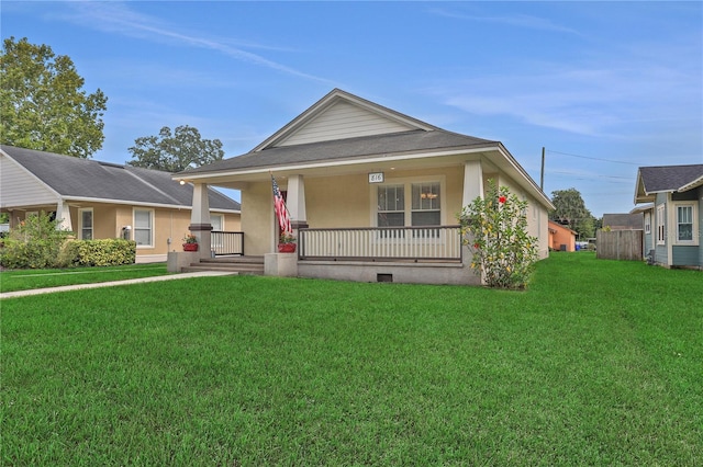 view of front of property with a front yard and covered porch