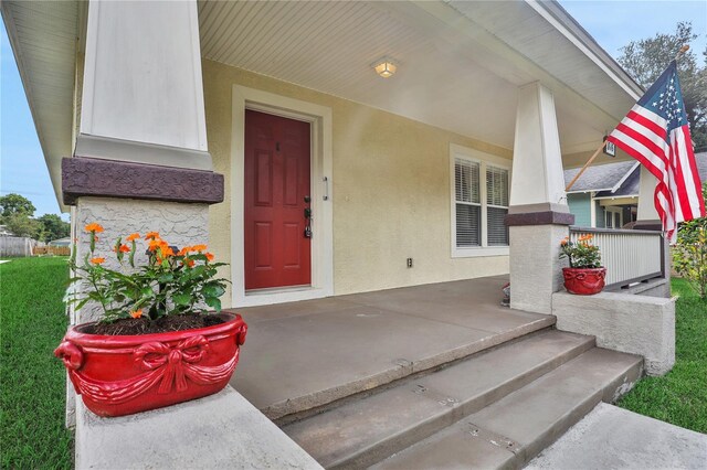 view of exterior entry with covered porch