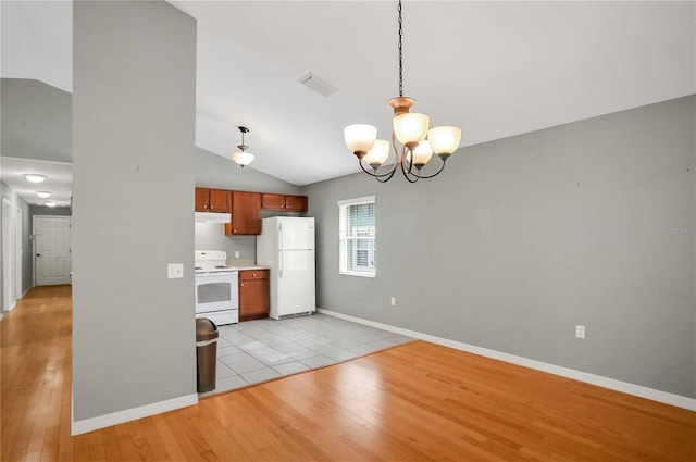 kitchen featuring white appliances, a chandelier, hanging light fixtures, vaulted ceiling, and light hardwood / wood-style floors