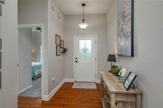 foyer featuring ceiling fan and dark hardwood / wood-style floors