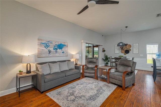 living room featuring ceiling fan, plenty of natural light, and dark hardwood / wood-style floors