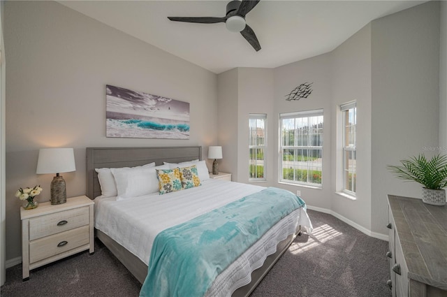 bedroom featuring dark colored carpet and ceiling fan