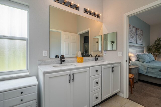 bathroom with tile patterned flooring and vanity