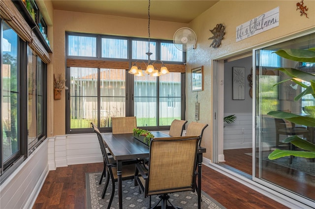 sunroom featuring a wealth of natural light and an inviting chandelier