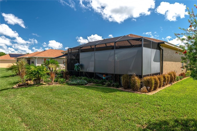 back of property featuring a yard and a lanai