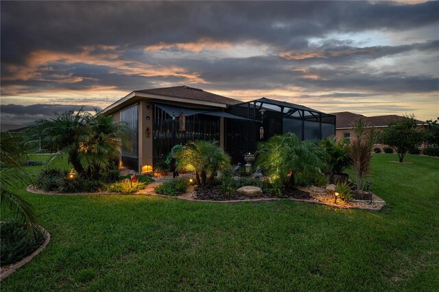 exterior space featuring a yard and a lanai