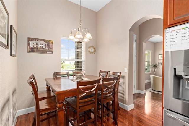 dining room with an inviting chandelier and dark hardwood / wood-style flooring