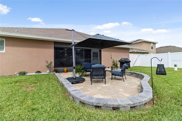 rear view of property with a lawn and a patio