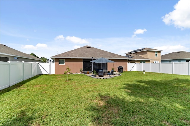 back of house featuring a patio area and a yard