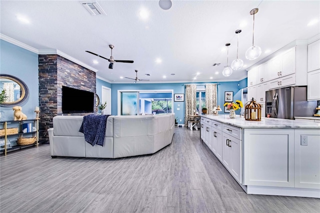 living room with crown molding, ceiling fan, and light hardwood / wood-style floors