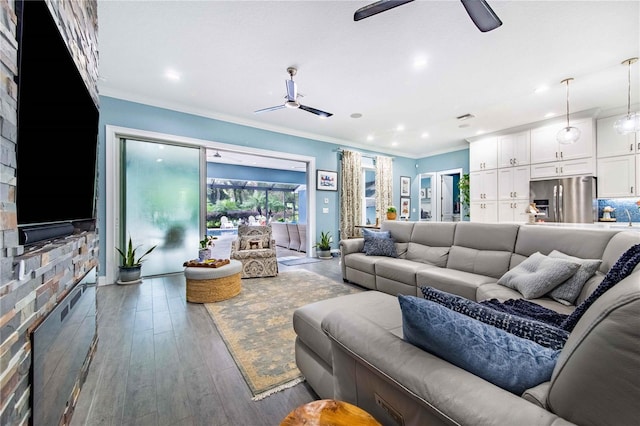 living room with ceiling fan, hardwood / wood-style flooring, and ornamental molding