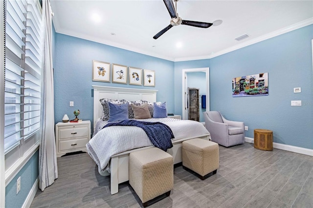 bedroom with light wood-type flooring, ceiling fan, and crown molding