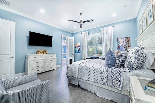 bedroom featuring ornamental molding, a fireplace, hardwood / wood-style floors, and ceiling fan