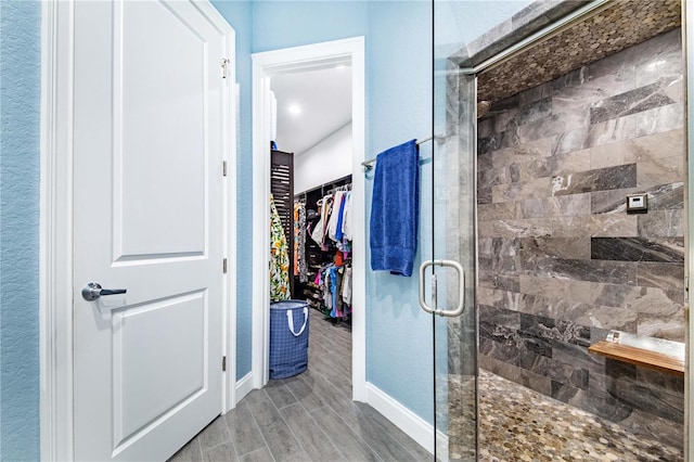 bathroom featuring an enclosed shower and hardwood / wood-style flooring