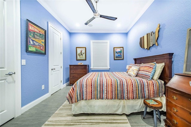 bedroom with hardwood / wood-style floors, ceiling fan, and ornamental molding