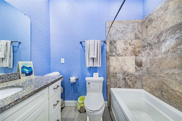 full bathroom featuring vanity, toilet, wood-type flooring, and tiled shower / bath