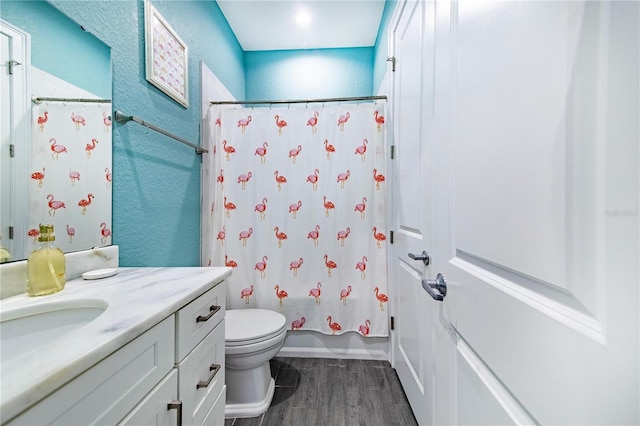 full bathroom featuring toilet, hardwood / wood-style flooring, shower / tub combo, and vanity