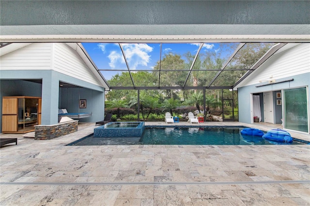 view of pool featuring a patio area, glass enclosure, and an in ground hot tub