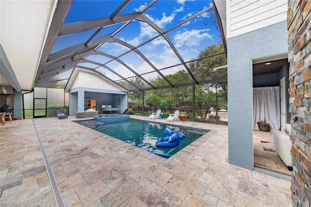 view of pool featuring glass enclosure and a patio