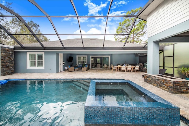 view of swimming pool featuring glass enclosure, a patio area, outdoor lounge area, and an in ground hot tub