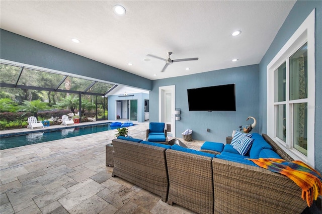 view of patio featuring glass enclosure, an outdoor hangout area, and ceiling fan