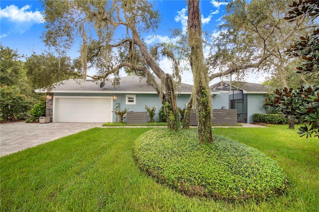 ranch-style home featuring a garage and a front lawn