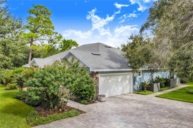 view of side of home featuring a yard and a garage