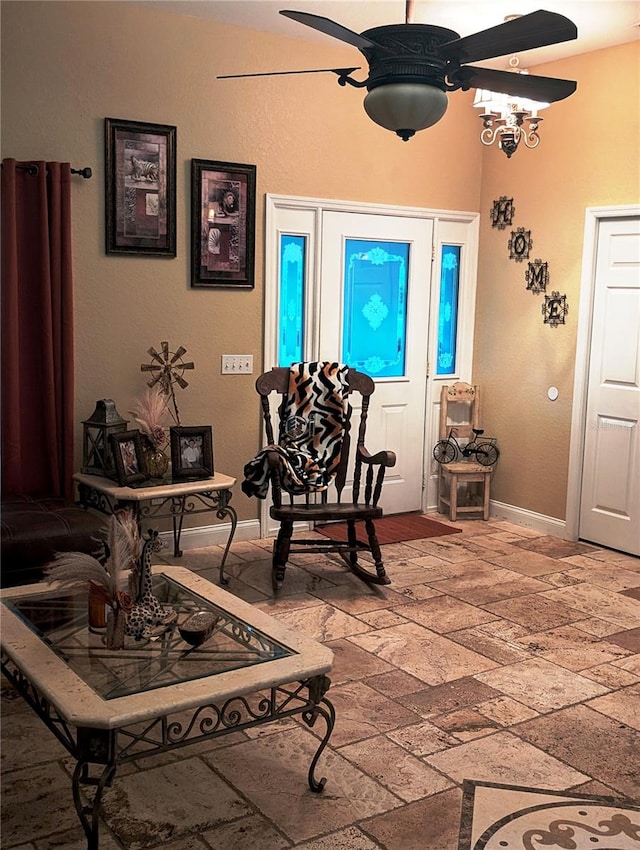 foyer entrance featuring ceiling fan