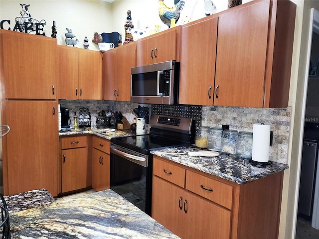 kitchen with appliances with stainless steel finishes, decorative backsplash, and light stone countertops