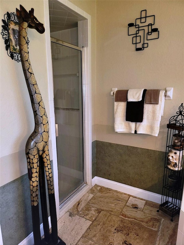 bathroom featuring a shower with shower door