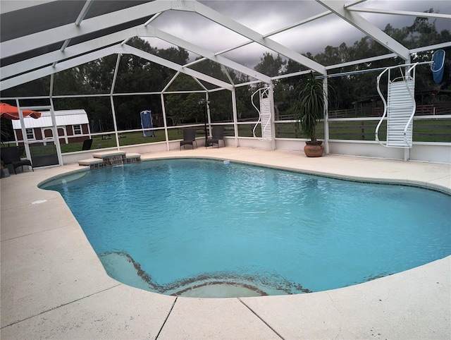 view of swimming pool with a lanai and a patio area