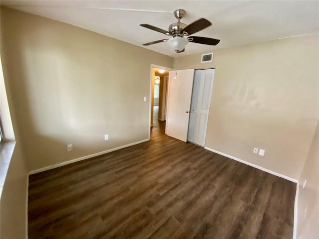 unfurnished bedroom with a closet, ceiling fan, and dark hardwood / wood-style flooring