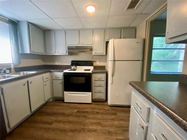 kitchen with white cabinetry, white appliances, a drop ceiling, and dark hardwood / wood-style floors