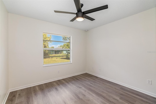 empty room featuring ceiling fan, dark hardwood / wood-style floors, and a textured ceiling