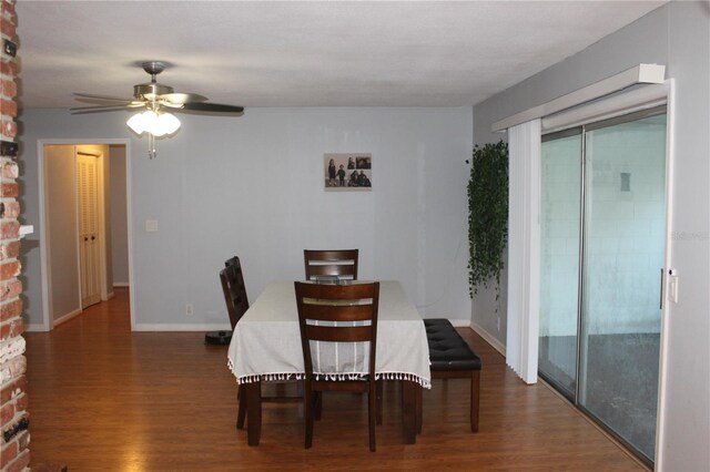 dining room with dark hardwood / wood-style floors and ceiling fan