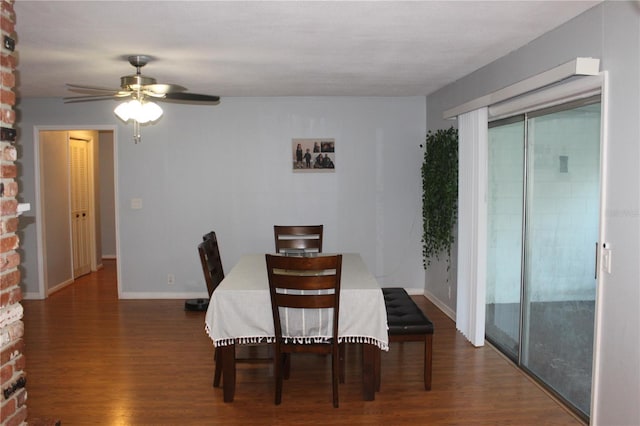 dining room with ceiling fan, baseboards, and wood finished floors