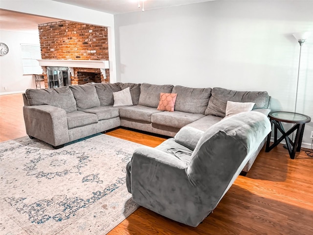 living room with hardwood / wood-style flooring and a fireplace