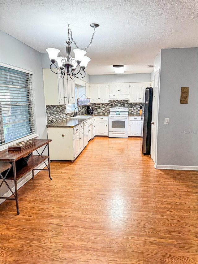 kitchen with light hardwood / wood-style floors, white cabinets, sink, and white appliances