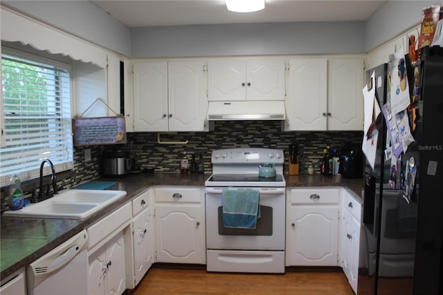 kitchen with backsplash, sink, white cabinetry, and white appliances