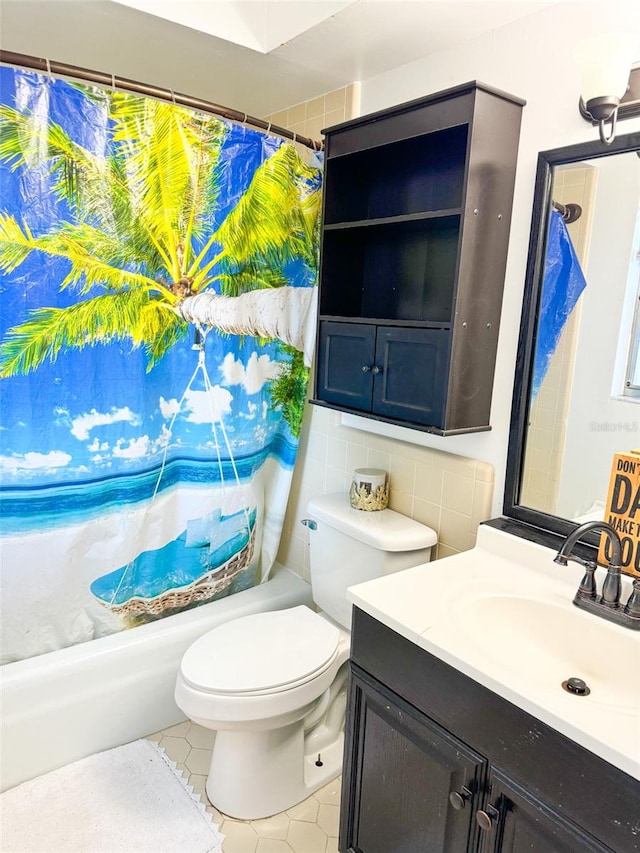 bathroom with tile patterned floors, shower / bath combo with shower curtain, toilet, tile walls, and vanity