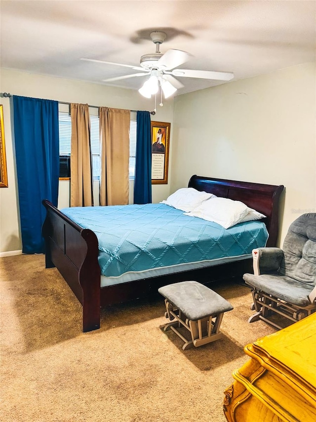 bedroom featuring a ceiling fan and carpet