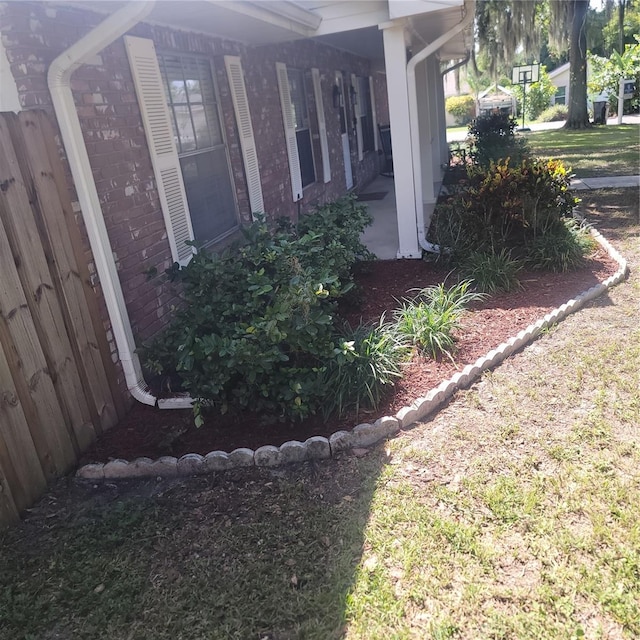 view of home's exterior featuring a porch and brick siding