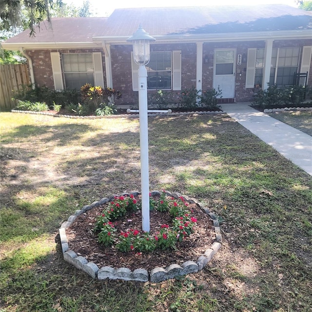 view of yard with fence and covered porch