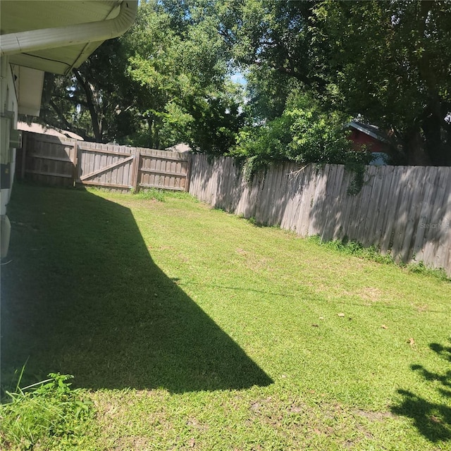 view of yard with a fenced backyard