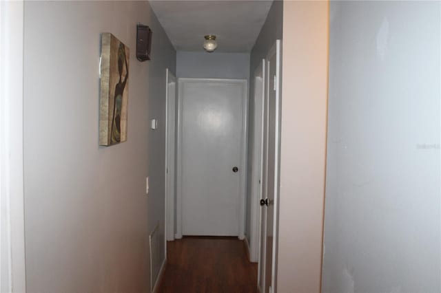 corridor with dark wood-type flooring